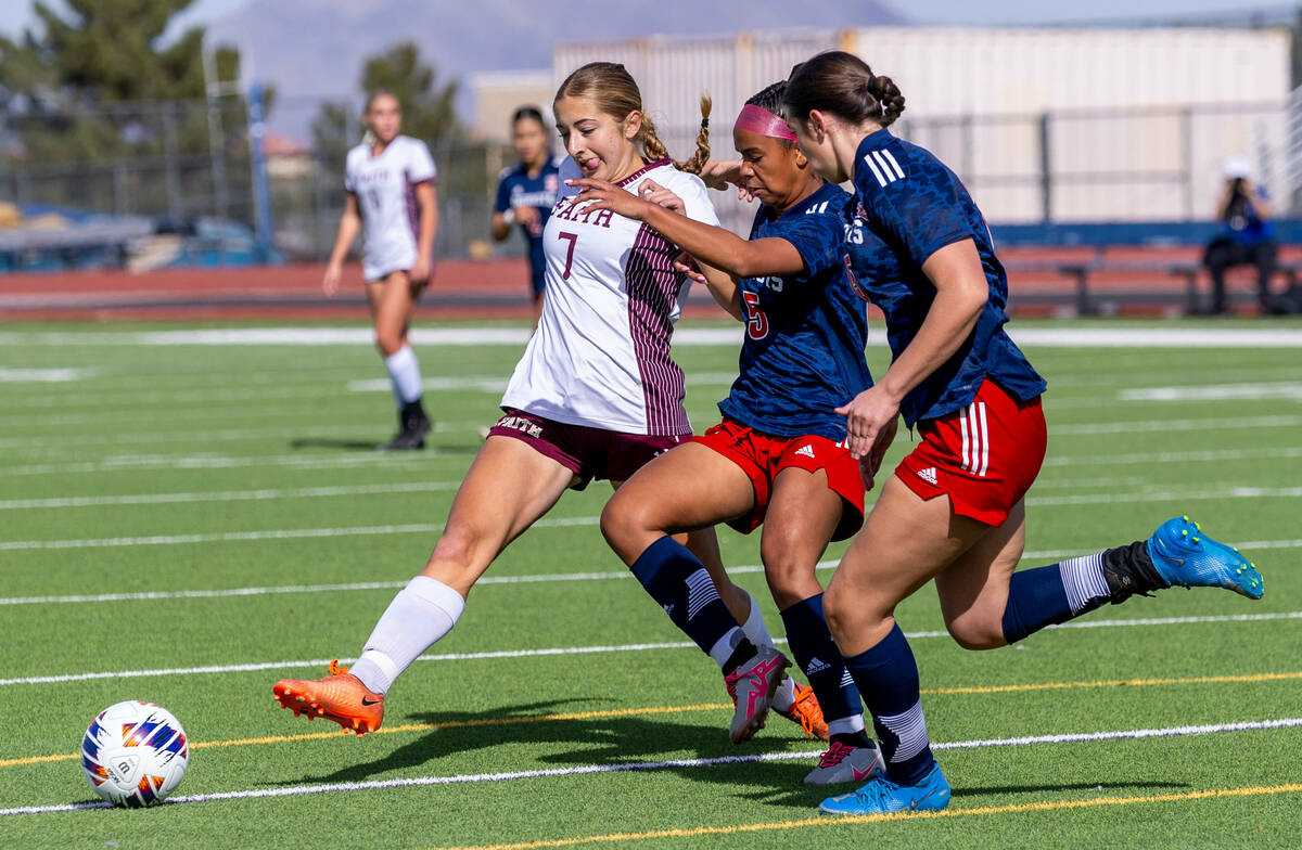 Faith Lutheran midfielder Julia Vancura (7) keeps the ball from Liberty forward Madalynn Smith ...