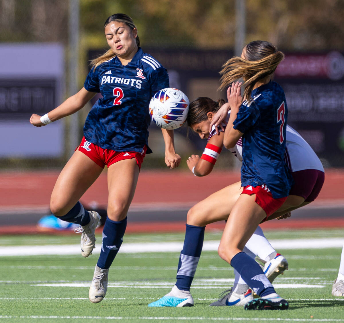 Liberty midfielder Natalie Collins (2) looks to a header by Faith Lutheran midfielder Andrea Le ...