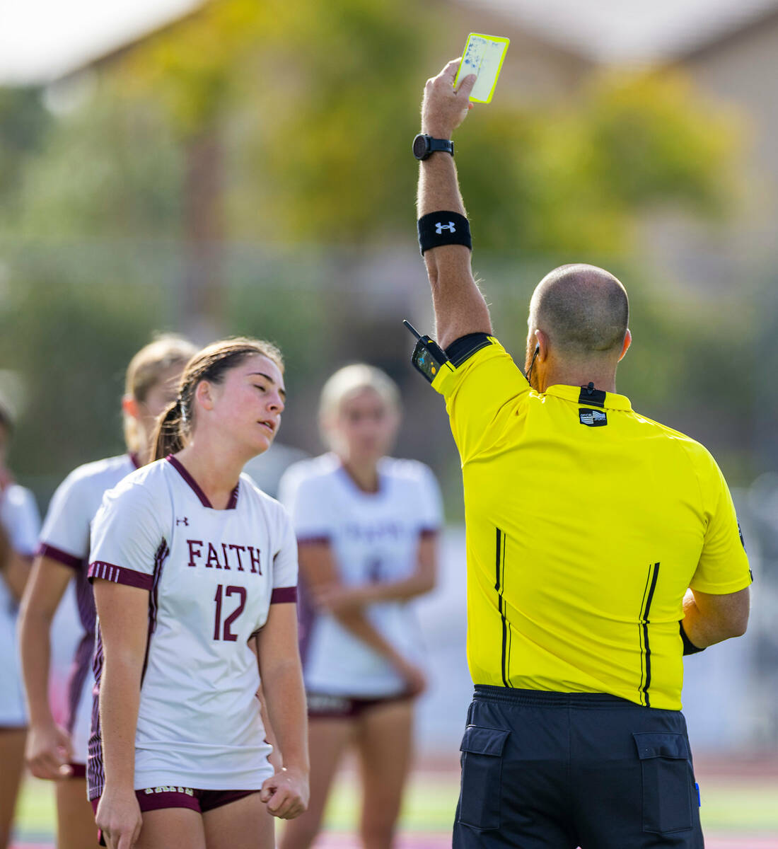 Faith Lutheran forward Lindely Amick (12) is given a yellow card after a bad hit on a Liberty p ...