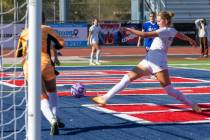 Coronado midfielder Ryan Neel (9) kicks a goal shot past Bishop Gorman goalkeeper Laila Lazzara ...