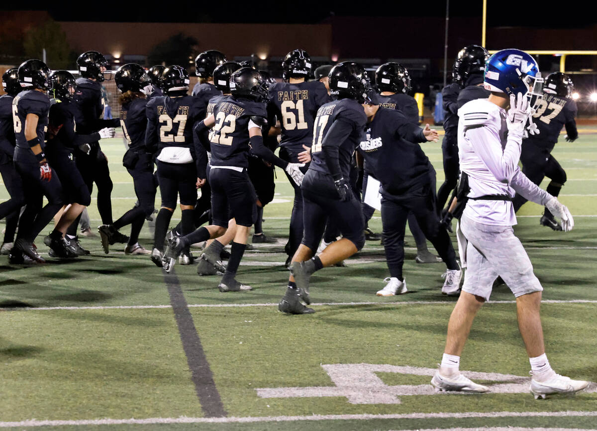 Green Valley's wide receiver Sean Mills (3) walks off the field as Faith Lutheran players celeb ...