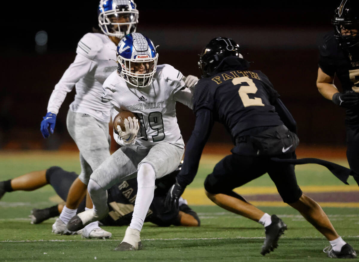 Green Valley's wide receiver Ben Byington (19) tries too avoid a tackle from Faith Lutheran's c ...