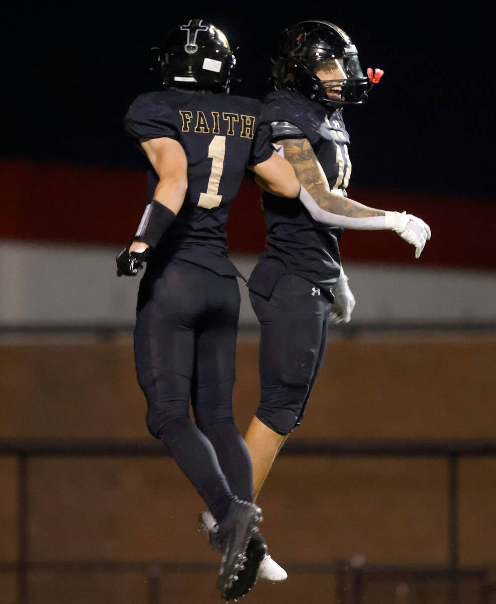 Faith Lutheran's Cale Breslin (14) celebrates his touchdown with teammate wide receiver Griffin ...