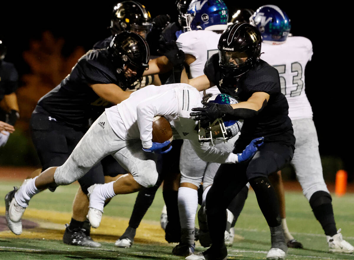 Faith Lutheran's Cole Keith (8) takes down Green Valley's Theo Edquilang (6) during the second ...