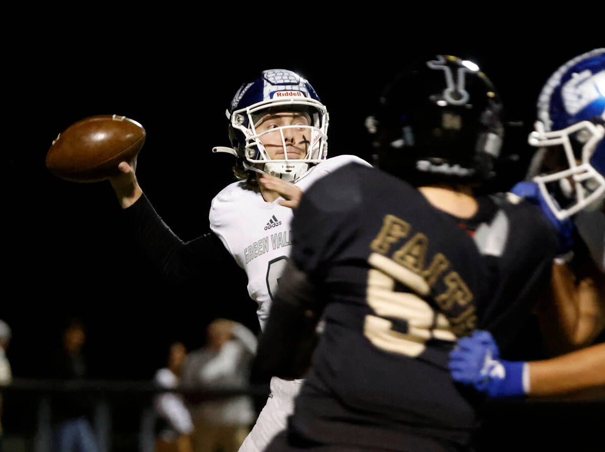 Green Valley's quarterback Jack Thow (9) throws under pressure from Faith Lutheran's Mack Ford ...