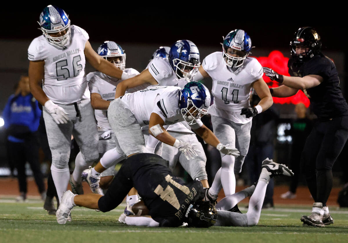 Faith Lutheran's running back Cale Breslin (14) is taken down by Green Valley defense during a ...