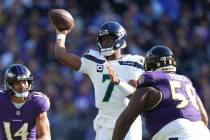 Seattle Seahawks quarterback Geno Smith (7) makes a pass attempt under pressure during an NFL f ...