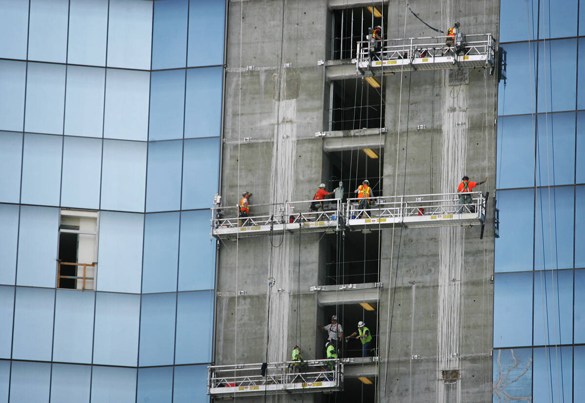 JASON BEAN/LAS VEGAS REVIEW-JOURNAL Construction workers hang above the strip while trying to ...