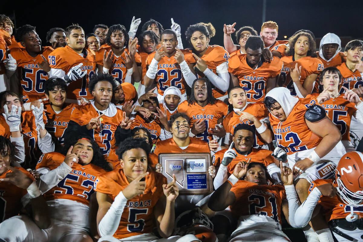 Legacy High School holds up the Class 5A Division III Southern League championship trophy after ...