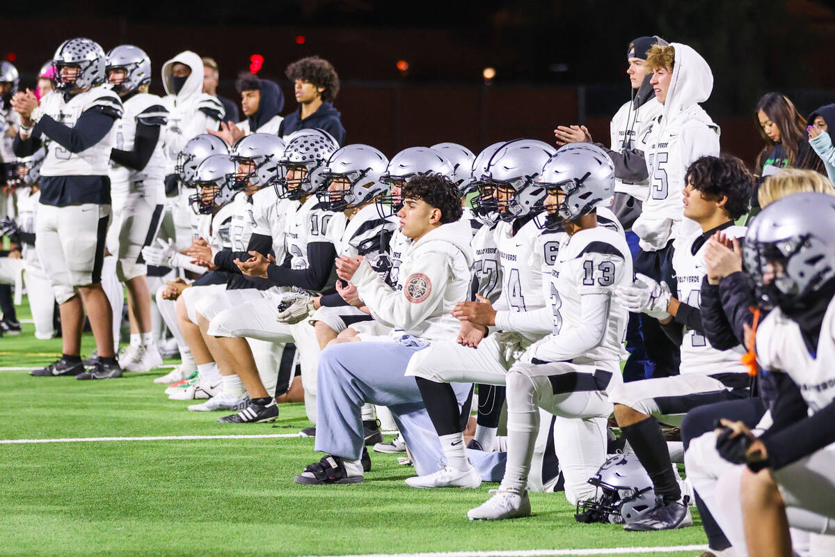 Palo Verde players take a knee as they await Legacy’s Dominic Oliver (1) to be helped by para ...