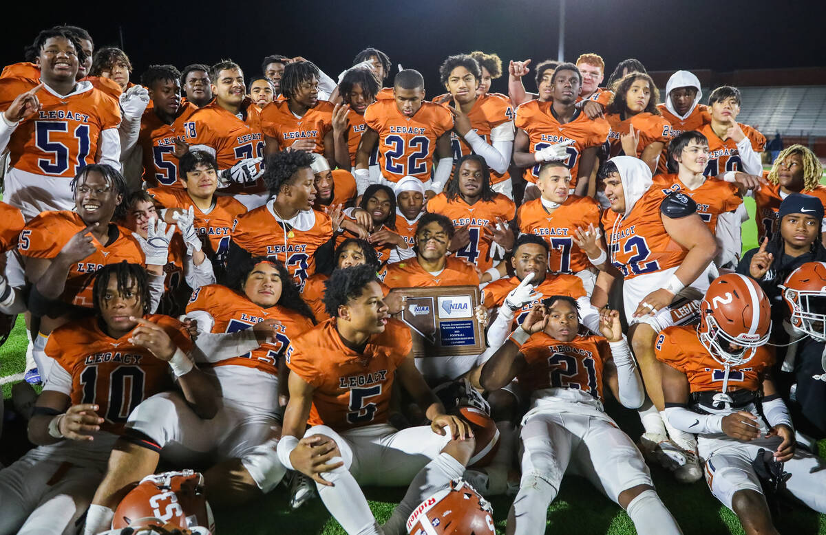 Legacy High School holds up the Class 5A Division III Southern League championship trophy after ...