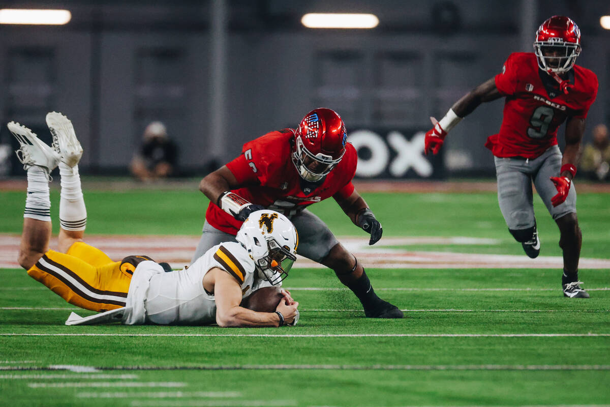 Wyoming quarterback Andrew Peasley (6) recovers a fumble during a game against UNLV at Allegian ...