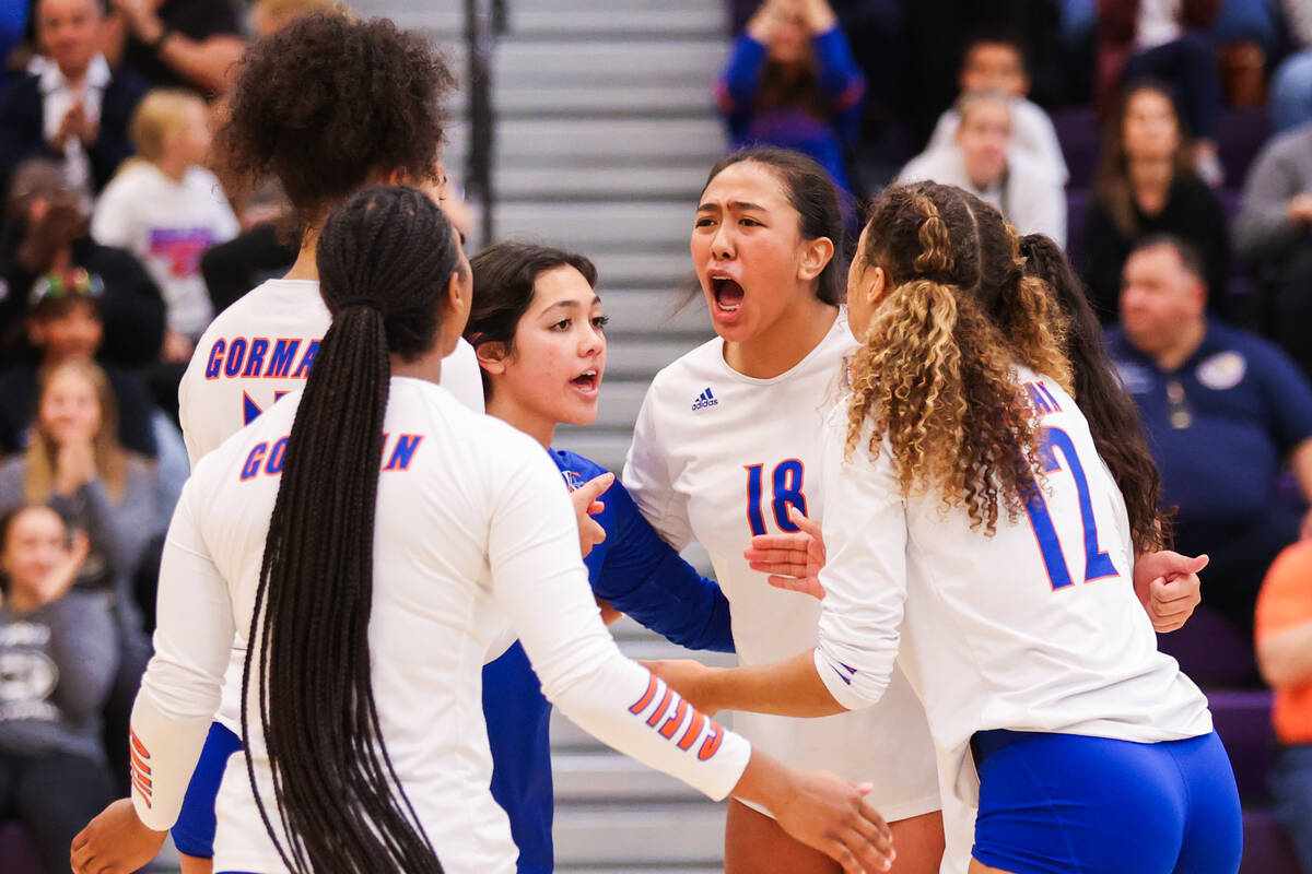 Bishop Gorman players hype each other up after winning a point during the class 5A girls volley ...