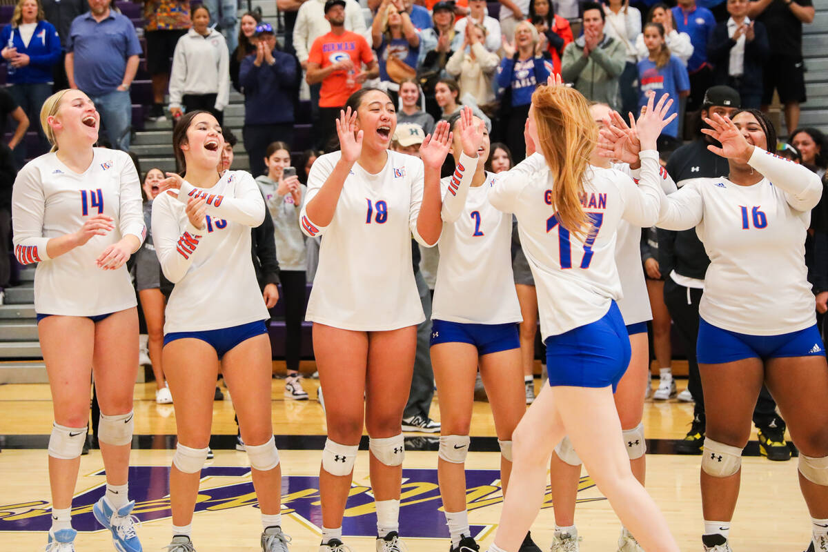 Bishop Gorman players congratulate eachother after winning the class 5A girls volleyball state ...