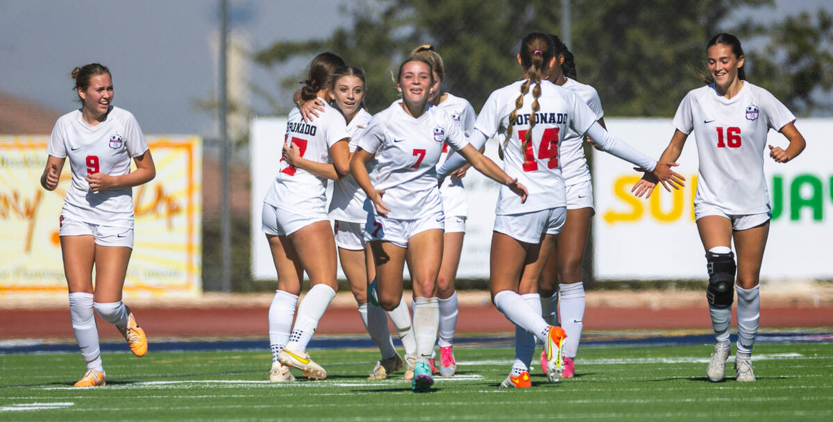 Coronado players celebrate their second goal against Faith Lutheran during the first half of th ...