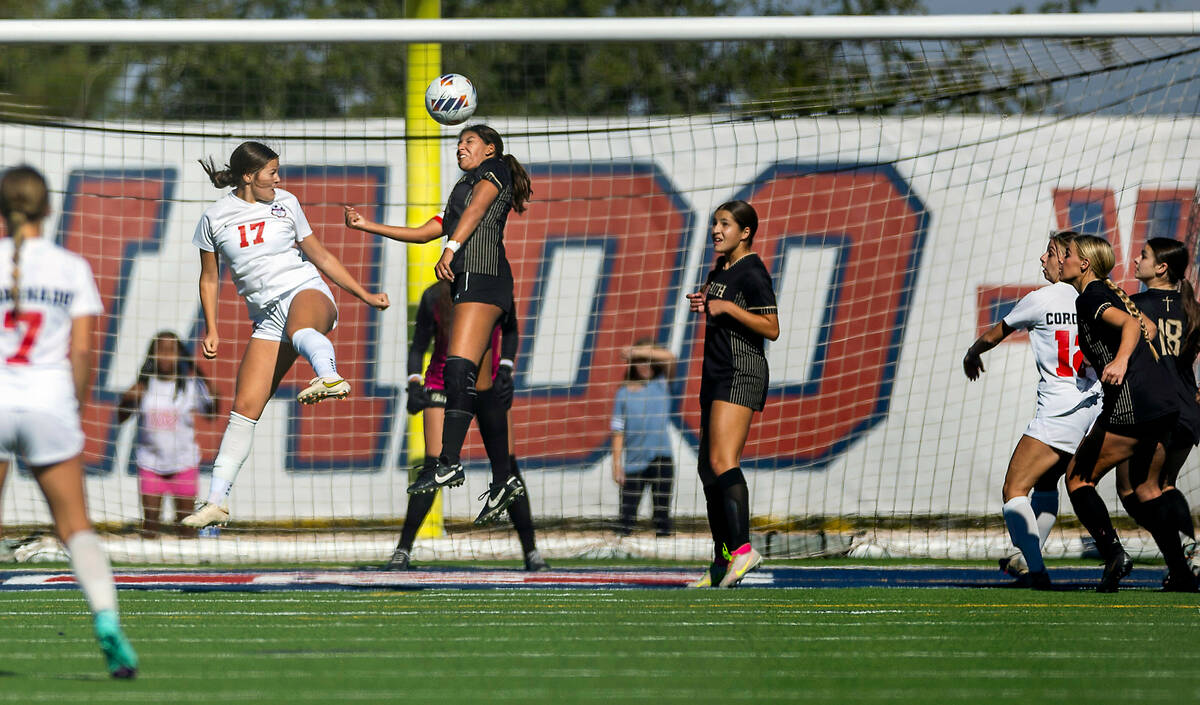 Faith Lutheran midfielder Andrea Leyva (10) heads the ball away after a possible goal shot with ...
