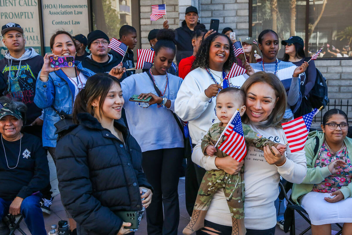 Crowds of people cheer on Veterans during the annual Veterans Day parade on 4th Street in downt ...