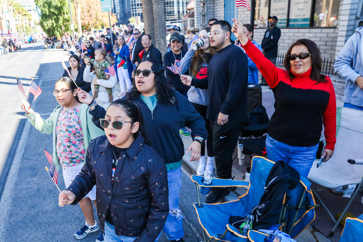 Crowds of people cheer on Veterans during the annual Veterans Day parade on 4th Street in downt ...