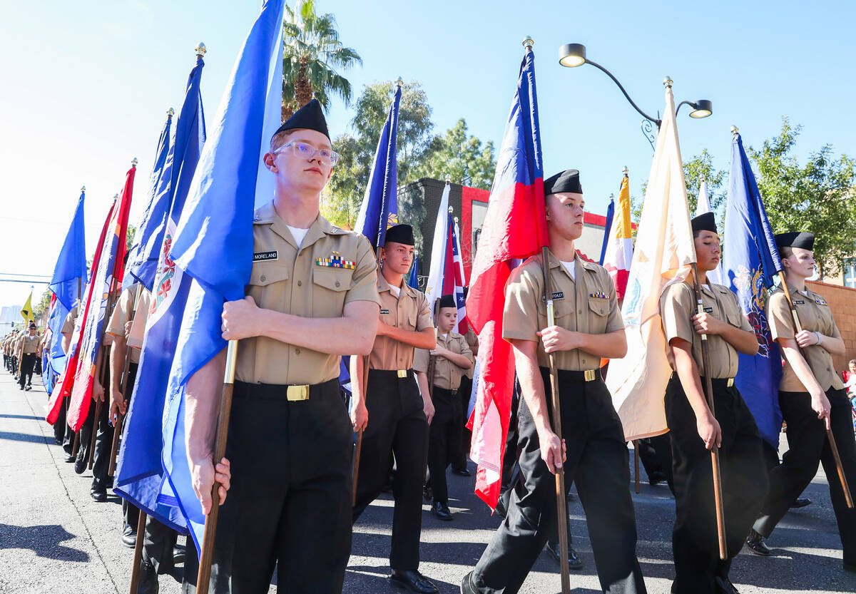 Centennial High School JROTC marches during the annual Veterans Day parade on 4th Street in dow ...