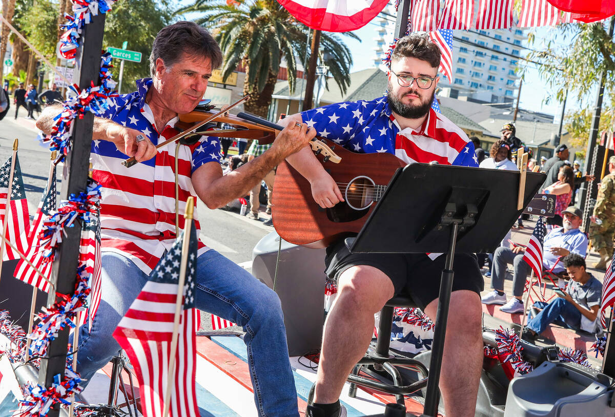 Musicians aboard the Americana Men Project float perform during the annual Veterans Day parade ...