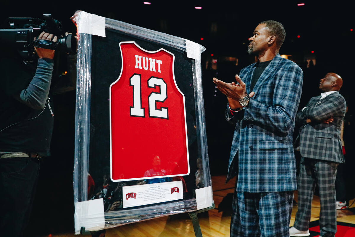 Anderson Hunt watches as a banner with his UNLV jersey number is revealed in the stands during ...