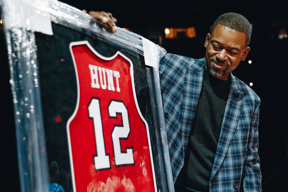 Anderson Hunt looks at his UNLV jersey during a jersey retirement ceremony at a game between UN ...