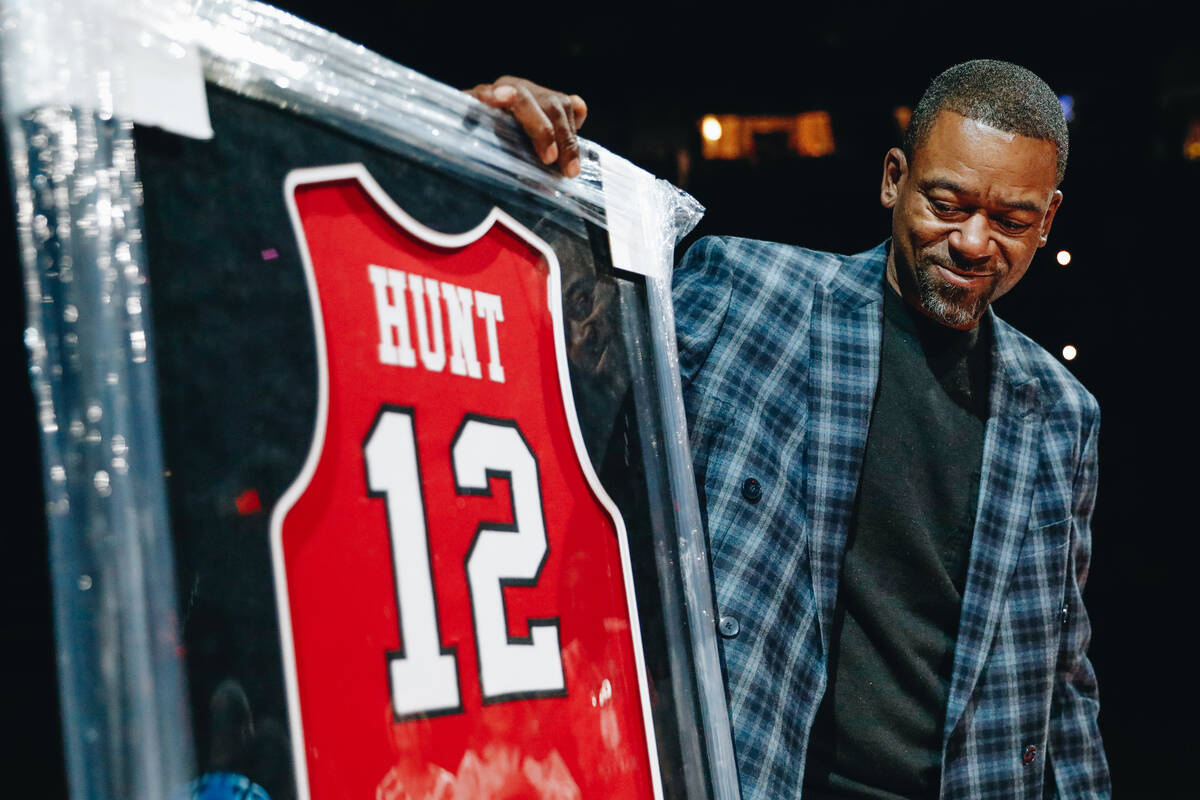 Anderson Hunt looks at his UNLV jersey during a jersey retirement ceremony at a game between UN ...