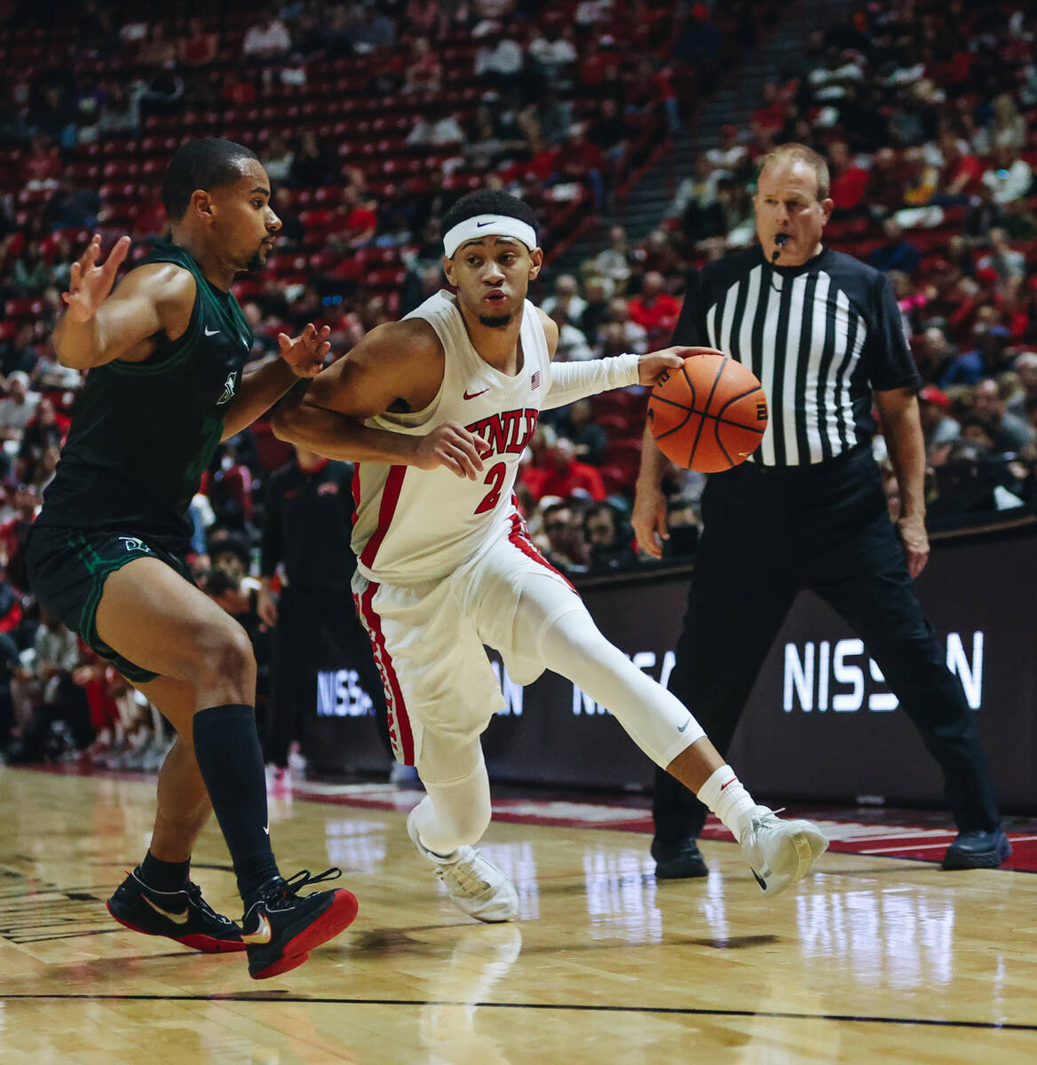 UNLV guard Justin Webster (2) dribbles the ball as Stetson guard Giancarlo Valdez (3) guards hi ...