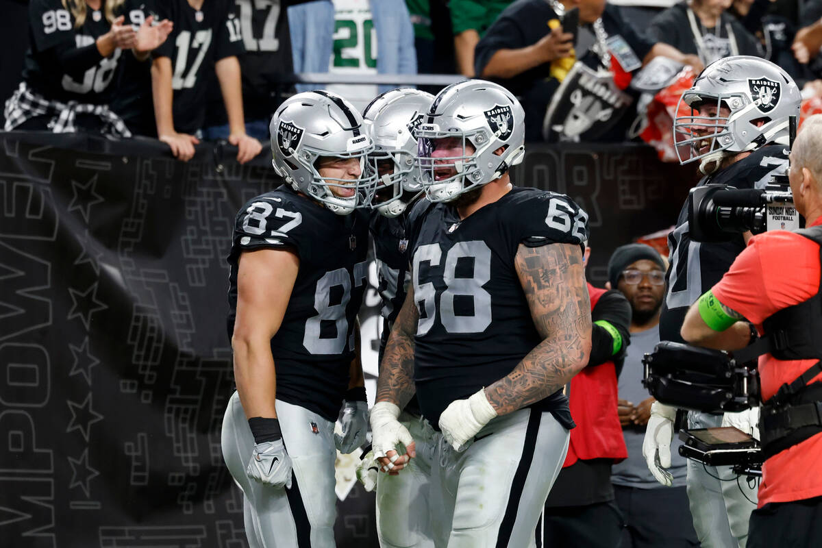 Raiders tight end Michael Mayer (87) celebrates his touchdown with teammates, including center ...