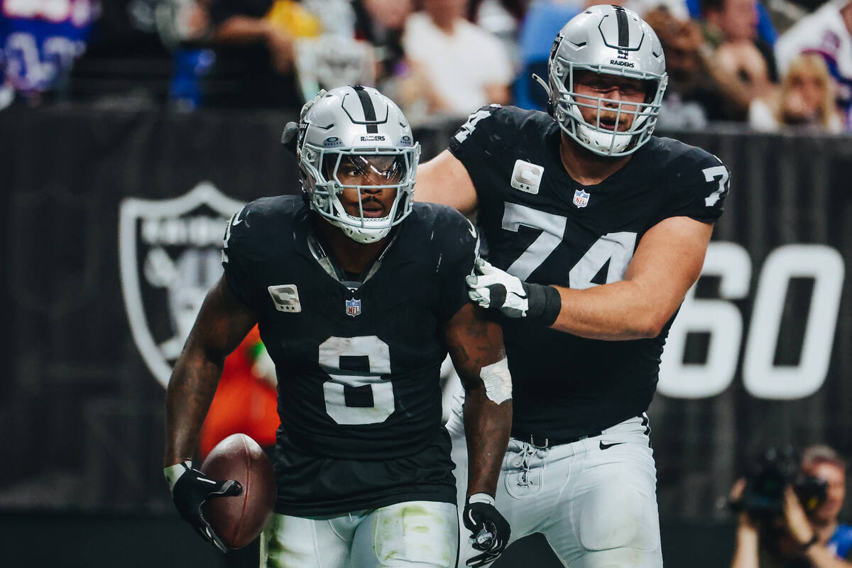 Raiders running back Josh Jacobs (8) and offensive tackle Kolton Miller (74) celebrate Jacob&#x ...