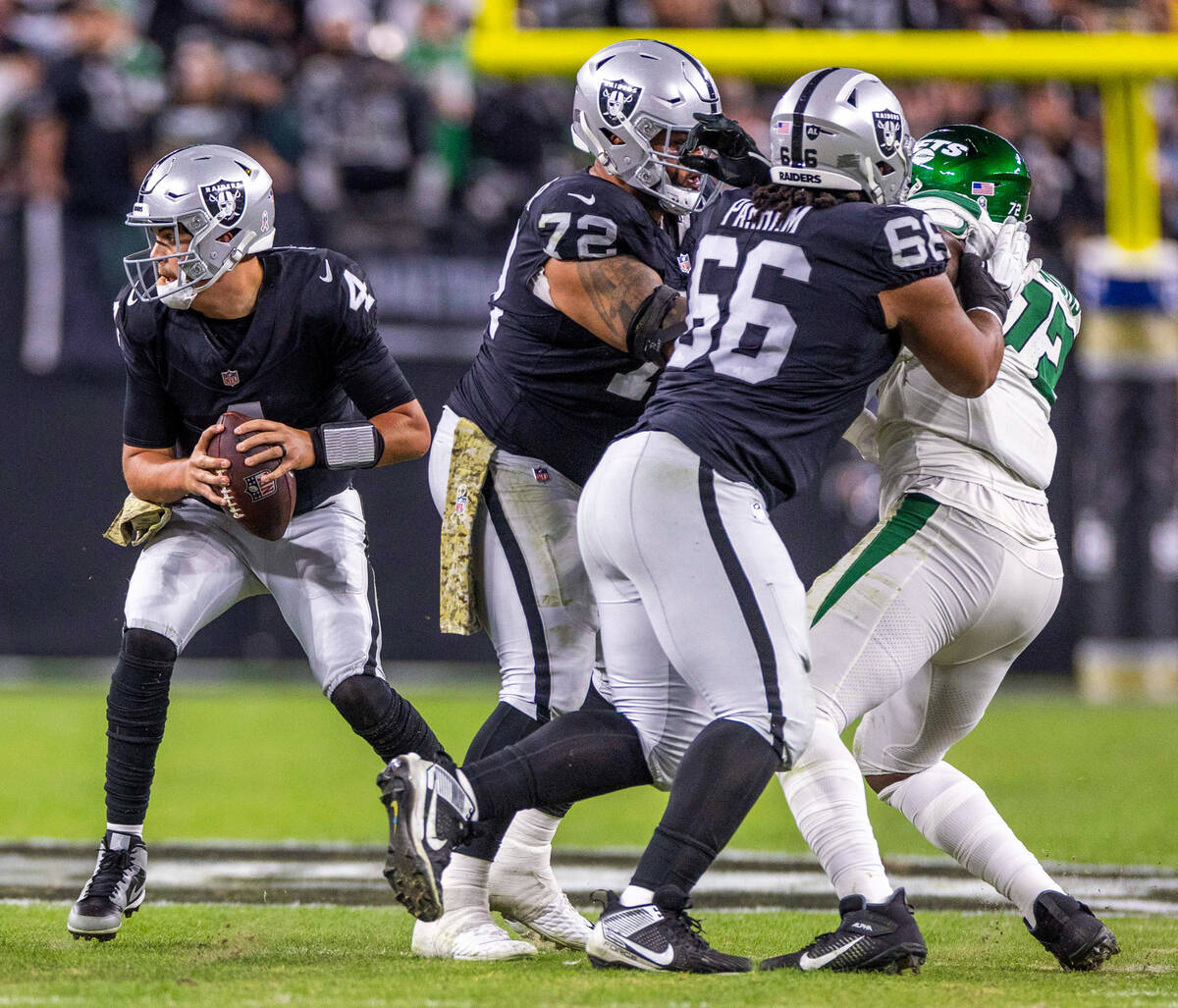 Raiders quarterback Aidan O'Connell (4) looks for room to run against the New York Jets during ...