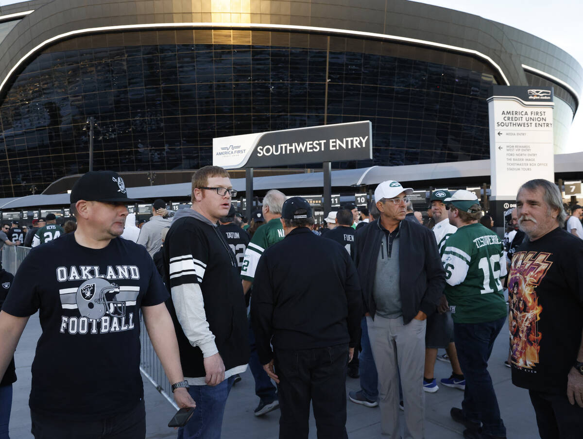 Raiders and New York fans arrive at Allegiant Stadium to watch their team play during an NFL fo ...