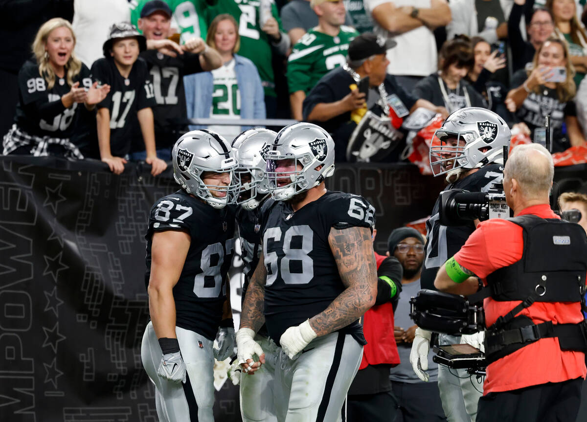 Raiders tight end Michael Mayer (87) celebrates his touchdown with teammates, including center ...