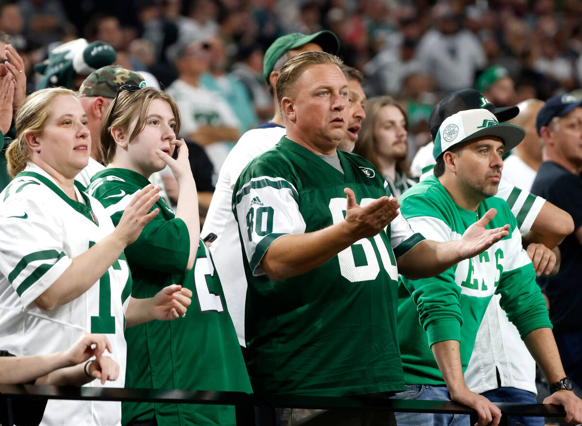 New York Jets fans react to a play as they watch their team lose to Raiders during the second h ...