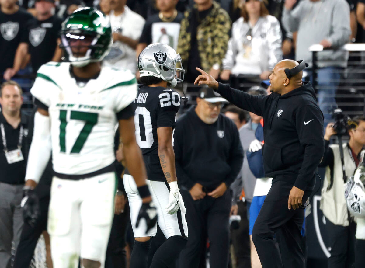 Raiders Interim Coach Antonio Pierce instructs his players during the first half of an NFL foot ...