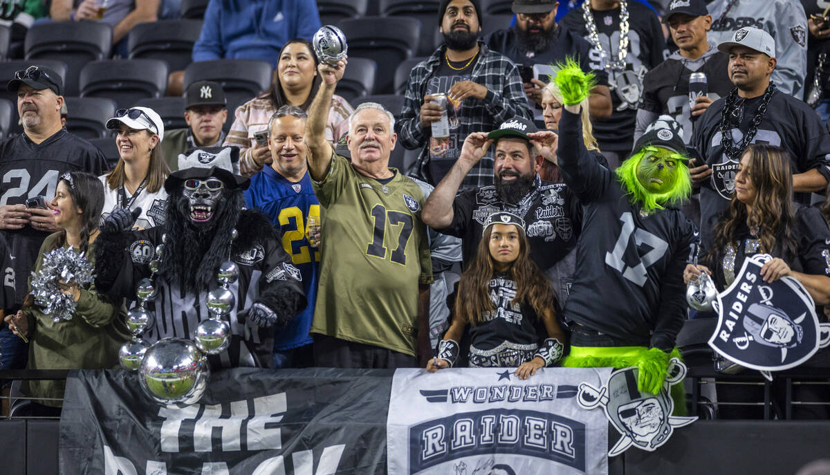 Raiders fans cheers for the team as they take the field during warmups before the first half of ...