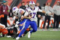 Buffalo Bills quarterback Josh Allen runs during the second half of an NFL football game agains ...