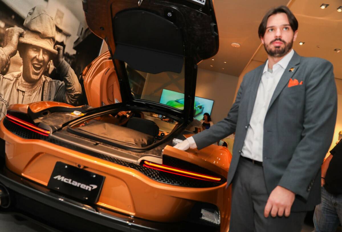 Joseph Marra, a luxury specialist, displays a 2023 McLaren GT at the McLaren Experience Center ...