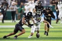 Hawaii wide receiver Chuuky Hines (84) and Air Force wide receiver Brandon Engel (2) fight for ...
