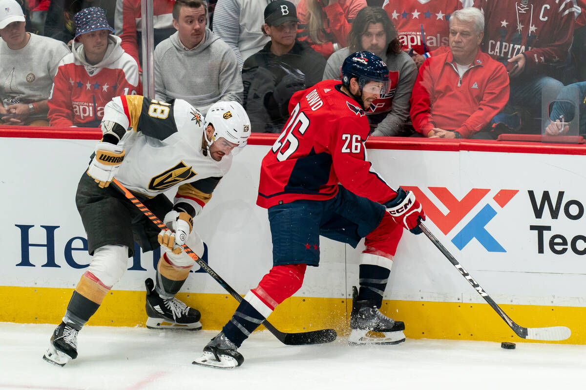 Vegas Golden Knights left wing William Carrier and Washington Capitals right wing Nic Dowd (26) ...
