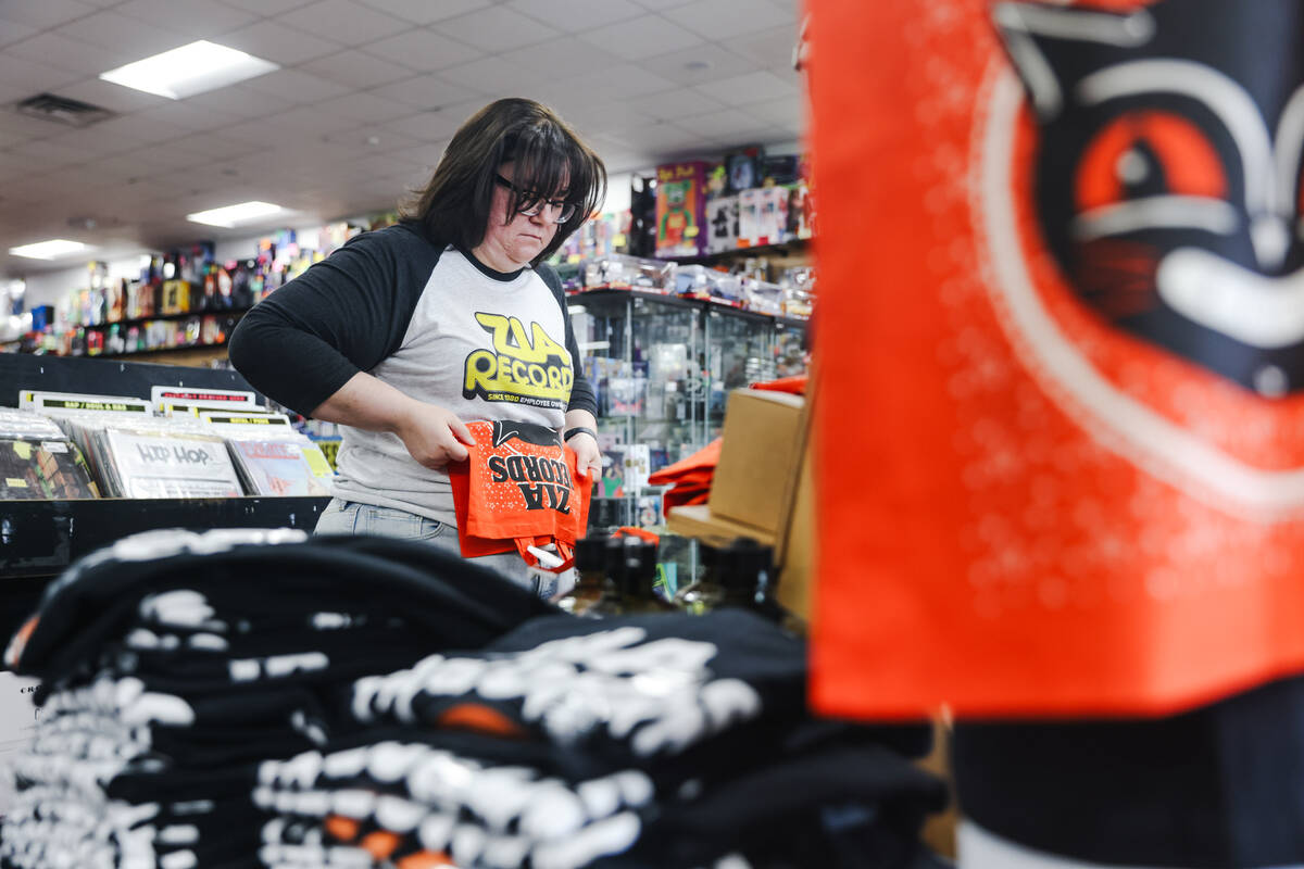 Christina Wilson folds clothes at Zia Records in Las Vegas, Monday, Nov. 13, 2023. (Rachel Asto ...