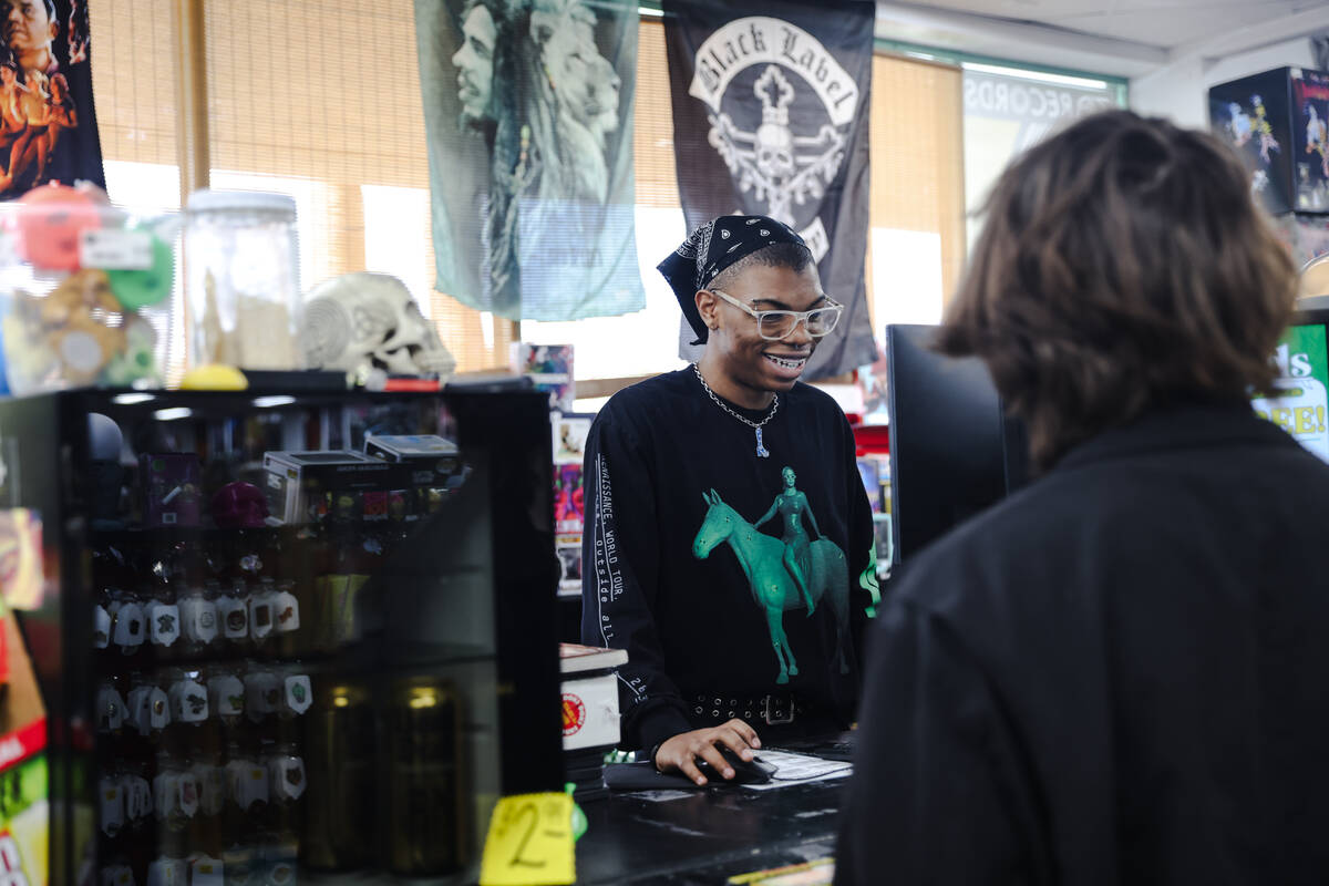 Kameron Franklin assists customers at Zia Records in Las Vegas, Monday, Nov. 13, 2023. (Rachel ...