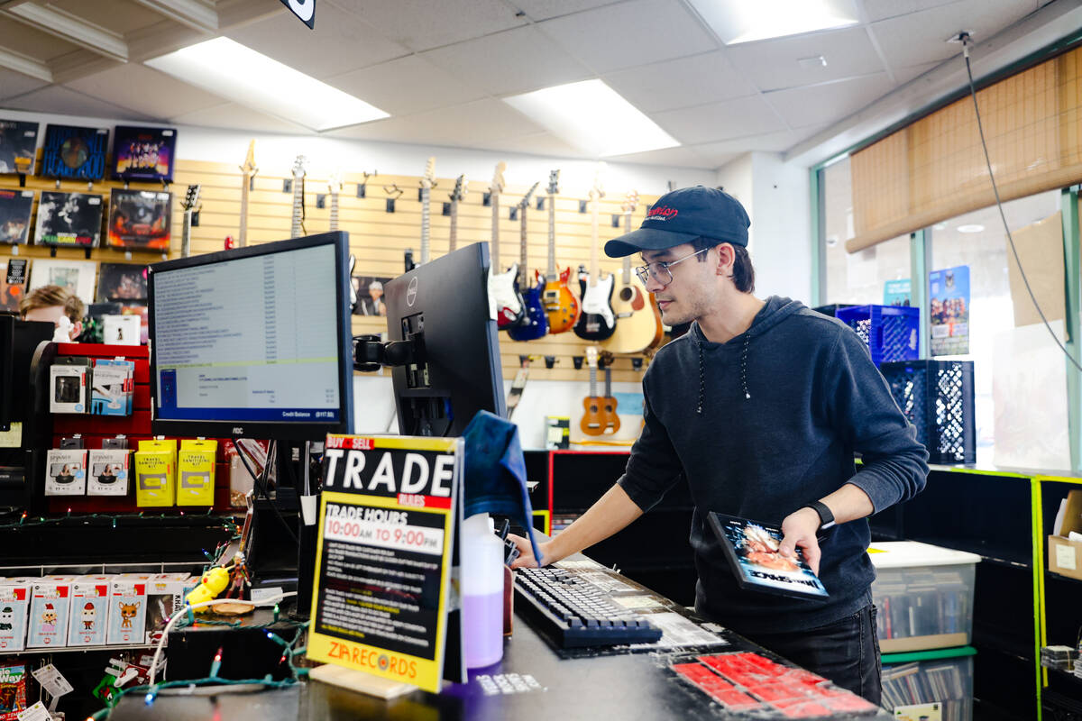 Stone Devereaux goes through merchandise at the trade counter at Zia Records in Las Vegas, Mond ...