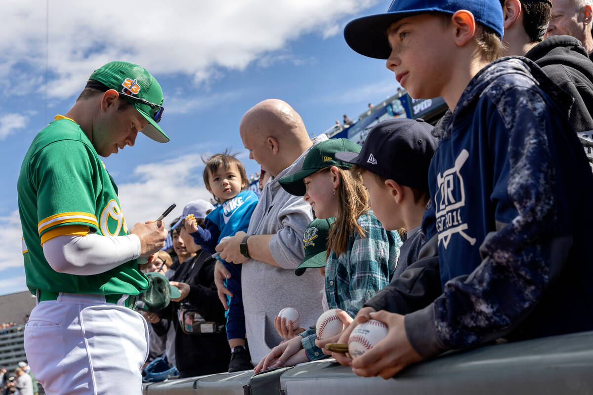 Oakland Athletics short stop Nick Allen signs autographs for fans before an MLB exhibition game ...