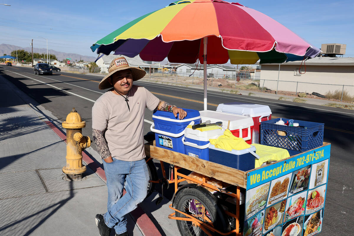 Street vendor Luis Serrano waits to serve customers in the Historic Westside in Las Vegas Tuesd ...
