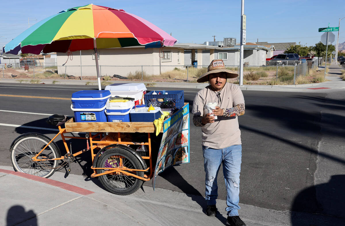 Street vendor Luis Serrano serves customers in the Historic Westside in Las Vegas Tuesday, Nov. ...