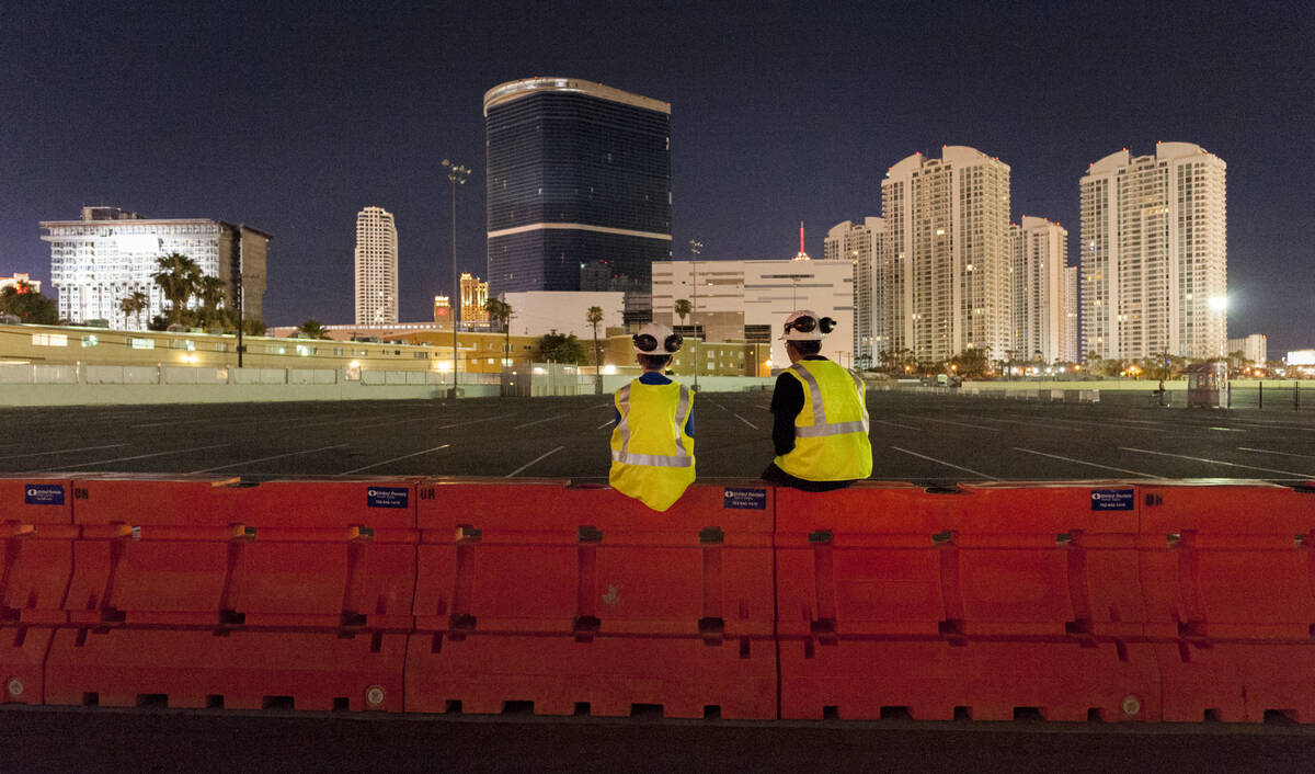 Gino Catania, left, and his cousin Vinny Catania wait on a barrier for the implosion of the rem ...