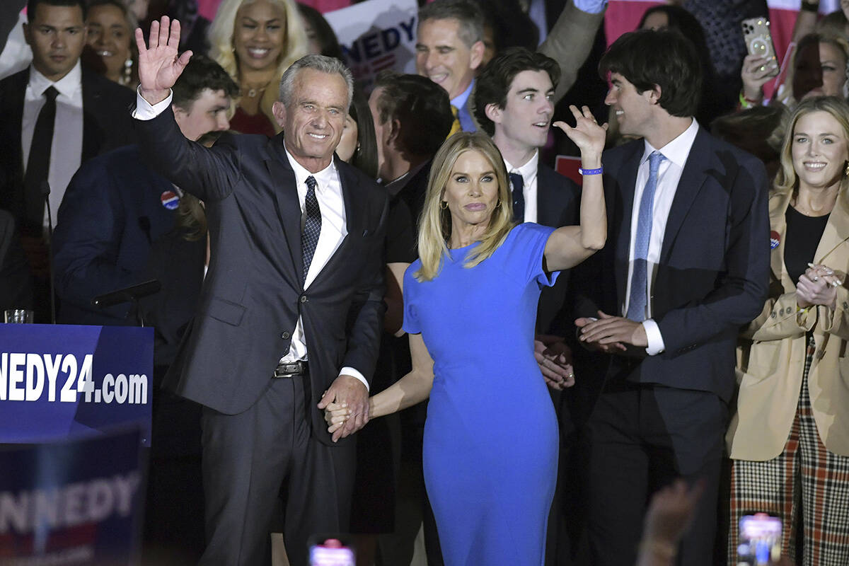 Robert F. Kennedy Jr. and wife Cheryl Hines wave with family members onstage at an event where ...