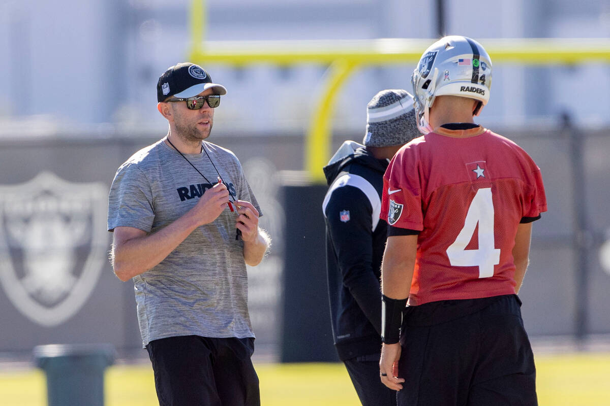 Raiders offensive coordinator Bo Hardegree works with quarterback Aidan O'Connell (4) during pr ...