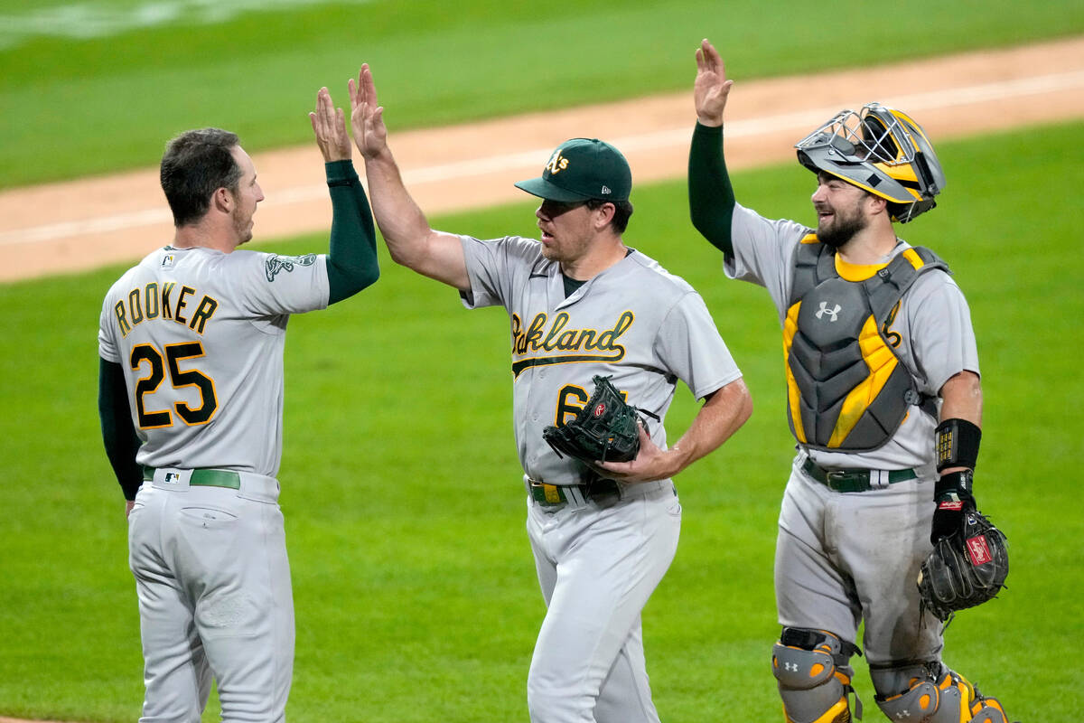 Oakland Athletics' Brent Rooker (25), Trevor May, center, and Shea Langeliers celebrate the tea ...